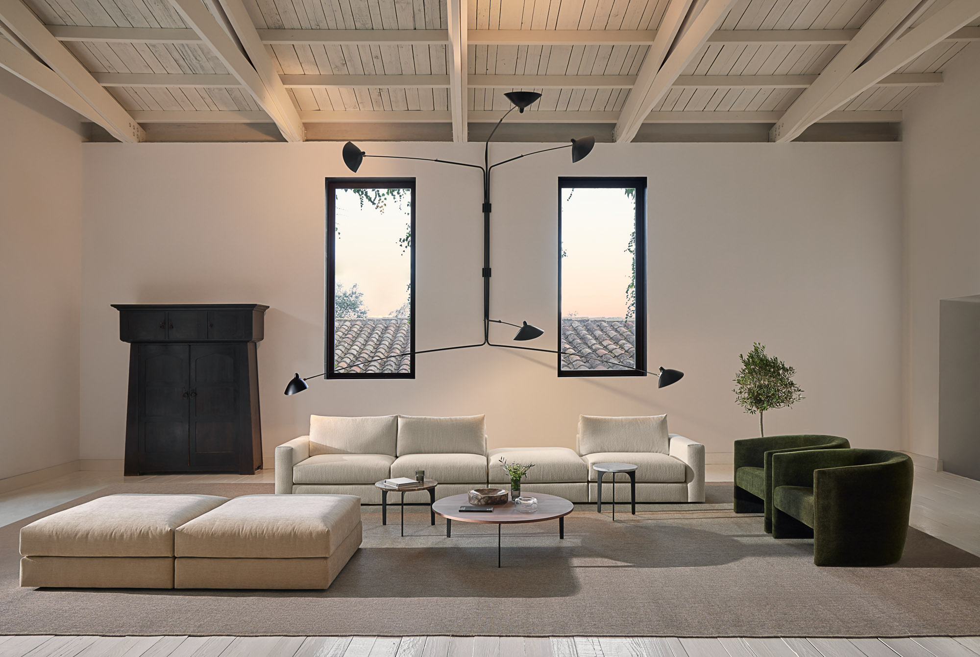 Front sofa system, Flow armchair and and Padi occasional tables designed by Mario Ruiz for Joquer