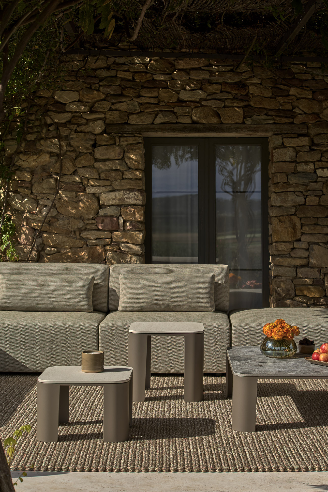 Bene outdoor tables and Serene Outdoor sofa system designed by Mario Ruiz