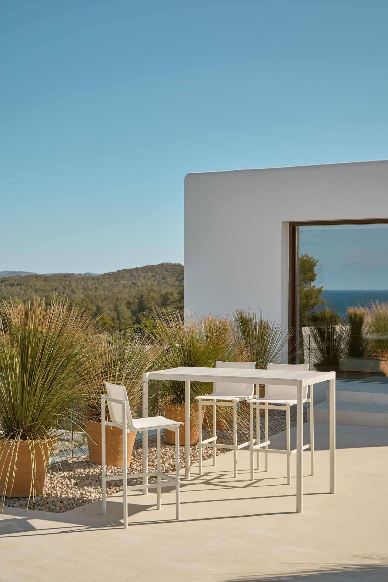 Origin outdoor high table and barstools designed by Mario Ruiz for Point