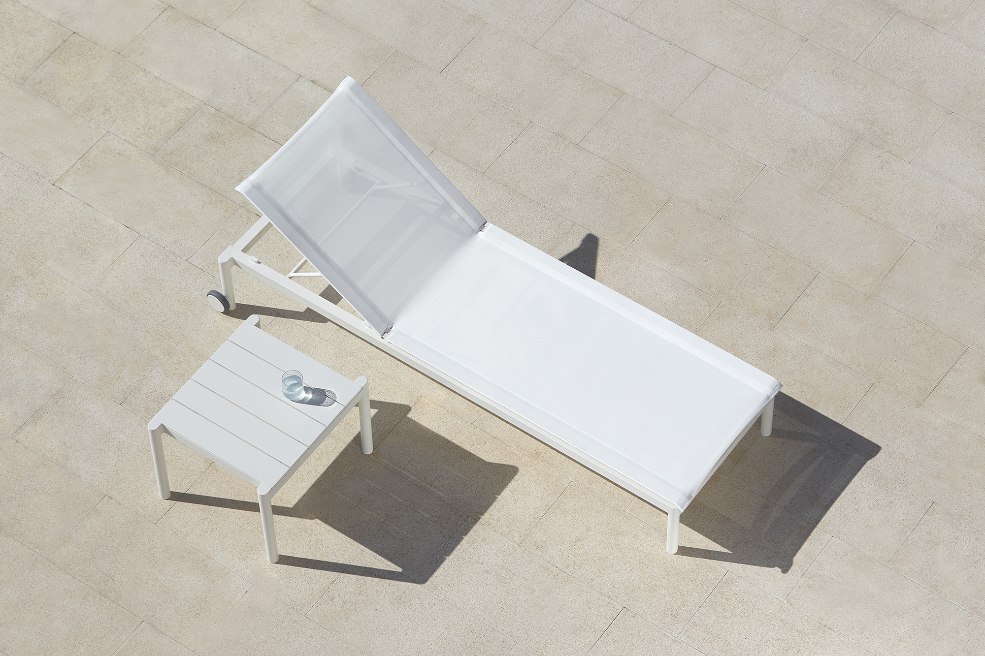 Origin Outdoor sun bed pool chaise and side table designed by Mario Ruiz for Point